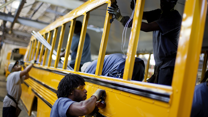 In this Friday, Sept. 18, 2015, photo, employees work on a school bus on the assembly line at Blue Bird Corporation's manufacturing facility, in Fort Valley, Ga. On Tuesday, March 1, 2016, the Institute for Supply Management, a trade group of purchasing managers, issues its index of manufacturing activity for February. (AP Photo/David Goldman)