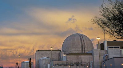 The sun rises behind Palo Verde Nuclear Generating Station Unit 3 as the unit reconnects to the electrical grid on November 5 after setting a record for the shortest refueling and maintenance outage in plant history. Palo Verde's three 1,330-megawatt generating units are on an 18-month refueling cycle, with two refueling outages scheduled each year - one in the spring and another in the fall. Palo Verde is operated by APS. (Photo: Business Wire)