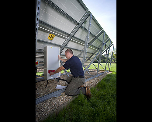 While not installed on a roof, this installation is properly aligned and workers can access it for maintenance.