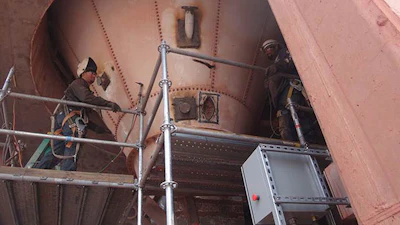 Contractors installing the pipe nozzles at a 30-degree angle to promote material flow.