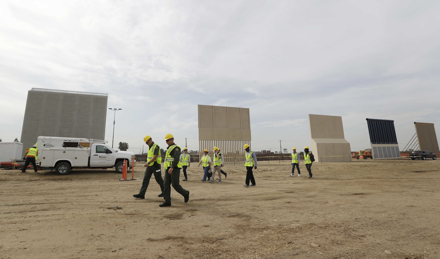 SAN DIEGO (AP) — The last two of eight prototypes for President Donald Trump's proposed border wall took shape Thursday at a construction site in San Diego. The prototypes form a tightly packed row of imposing concrete and metal panels, including one with sharp metal edges on top. Another has a surface resembling an expensive brick driveway. Companies have until Oct. 26 to finish the models but Border Patrol spokesman Theron Francisco said the last two came into profile, with crews installing a corrugated metal surface on the eighth model on a dirt lot just a few steps from homes in Tijuana, Mexico. As the crews worked, three men and two women from Nepal, ages 19 to 30, jumped a short rusted fence from Tijuana into the construction site and were immediately stopped by agents on horseback. Francisco said there have been four or five other illegal crossing attempts at the site since work began Sept. 26. The models, which cost the government up to $500,000 each, were spaced 30 feet (9.1 meters) apart. Slopes, th