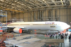 I climbed up a platform inside U-Tapao’s aircraft maintenance hangar to get this view of a Thai Airways commercial passenger plane being serviced.