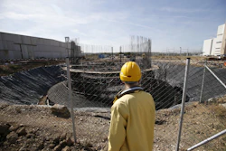 In this photo taken Wednesday, Oct. 3, 2018, a worker inspects works on huge chimney for the new, so-called 'Kostolac Bloc 3' in Serbia's main coal-fired power station near Kostolac, Serbia. The Kostolac power plant complex in eastern Serbia is currently being expanded with a $715 million loan from a Chinese state bank and constructed by one of China's largest companies. (AP Photo/Darko Vojinovic)