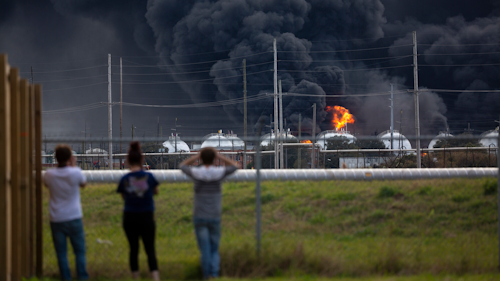 Residents observe the fire consuming the TPC Group plant on Wednesday, Nov. 27, in Port Neches, TX.