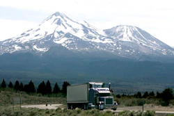 In this June 19, 2008 file photo, a truck drives past Mt. Shasta, near Weed, Calif. California regulators will hold a public hearing on Thursday, Dec. 12, 2019 about whether to require a certain percentage of truck sales to be zero emission vehicles. California has some of the worst air quality in the nation, largely driven by pollution from cars and trucks.
