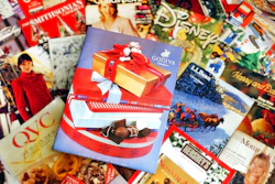 This Wednesday, Nov. 24, 2004 file photo shows a selection of holiday season catalogs in Portland, Maine. Catalogs, those glossy paper-and-ink offerings of outdoor apparel, kitchenware and fruit baskets, are not yet headed for the recycling bin of history.