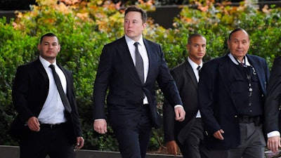 Tesla CEO Elon Musk, second from left, arrives at U.S. District Court Wednesday, Dec. 4, 2019, in Los Angeles. Musk is going on trial for his troublesome tweets in a case pitting the billionaire against a British diver he allegedly dubbed a pedophile.