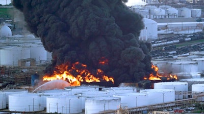 In this Monday, March 18, 2019 file photo, Firefighters battle a petrochemical fire at the Intercontinental Terminals Company in Deer Park, Texas. A fire at a Houston-area petrochemical storage facility that burned for days in March was accidental and caused by equipment failure at a storage tank, according to a report released by local and federal investigators, Friday, Dec. 6, 2019.