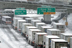 In this Jan. 11, 2017, file photo, early morning traffic is at a standstill on Interstate 5 headed into town as a semi truck and cars block the off ramp to Highway 217 above in Portland, Ore. A federal watchdog says the Trump administration moved to exempt a type of super-polluting cargo truck from clean air rules without conducting a federally mandated study on how it would impact public health.