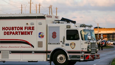 In this Sunday, Dec. 15, 2019 photo, officials respond to the scene of a mercury spill on the intersection of Westview Drive and West Sam Houston Parkway North. A person has been taken into custody for questioning after dozens of people were decontaminated as a precaution due to trace amounts of mercury spilled at three locations in Houston, the FBI said Monday.