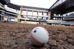A baseball lies on packed dirt after for a short batting practice during a tour of the under construction baseball field at the new Texas Rangers stadium in Arlington, Texas, Wednesday, Dec. 4, 2019.