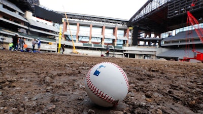 A baseball lies on packed dirt after for a short batting practice during a tour of the under construction baseball field at the new Texas Rangers stadium in Arlington, Texas, Wednesday, Dec. 4, 2019.