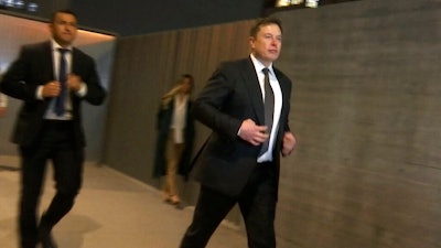 In this frame grab from video, Tesla CEO Elon Musk leaves court, Tuesday, Dec. 3, 2019, in Los Angeles. Musk denied that he meant to call a British cave diver a pedophile when he dubbed him 'pedo guy' on social media.