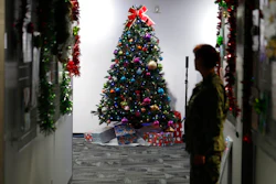 A decorated tree stands in the NORAD Tracks Santa Center at Peterson Air Force Base, Monday, Dec. 23, 2019, in Colorado Springs, Colo. More than 1,500 volunteers will handle an estimated 140,000 telephone inquiries from around the globe from children and their parents on the whereabouts of Santa Claus on Christmas Eve.
