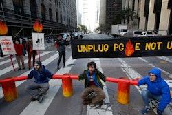 Protesters block traffic on Beale Street where a Pacific Gas & Electric building is located in San Francisco, Monday, Dec. 16, 2019. Pacific Gas & Electric will have to quickly reshuffle its board of directors and redraw a complex plan addressing more than $50 billion in potential wildfire claims to gain Gov. Gavin Newsom's support in time to meet a fast-approaching deadline to emerge from bankruptcy protection.