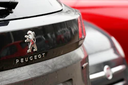A Peugeot 3008 car is parked flanked by a 500 Fiat car in Milan, Italy, Wednesday, Dec. 18, 2019. Fiat Chrysler and PSA Peugeot have signed a deal for a 50-50 merger, creating the world's fourth-largest automaker with annual sales of 8.7 million cars.