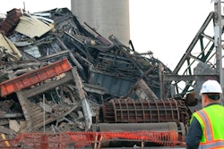 A person looks on as DTE Energy Co.'s old Conners Creek Power Plant is demolished Friday, Dec. 13, 2019, in Detroit. The power plant that was more than 100 years old was demolished Friday to accommodate a Jeep factory.