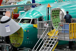 In this March 27, 2019, file photo, a worker enters a Boeing 737 MAX 8 airplane during a brief media tour of Boeing's 737 assembly facility in Renton, Wash. On Monday, Dec. 16, shares of Boeing are falling before the opening bell on a report that the company may cut production of its troubled 737 Max or even end production all together.