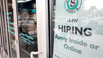In this Nov. 4, 2019, file photo a job posting is displayed near the entrance outside a restaurant in Orlando, Fla. Two reports last week show that small business hiring still lags behind the strong job growth reported at larger companies, and that owners are unlikely to increase their staffs significantly in 2020.