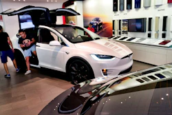 In this Aug. 8, 2018, file photo, customers check out the Tesla X, at the Tesla showroom in Santa Monica, Calif. California's rebate program to entice more drivers to purchase electric vehicles got less generous, especially for those looking to buy luxury models. Effective Tuesday, Dec. 3, 2019, regulators stopped offering rebates for electric cars or plug-in hybrids that cost more than $60,000.