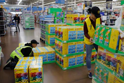 In this Nov. 27, 2019 file photo, Jayln Martin, right, and Dan Villegas stock items in preparation for a holiday sale at a Walmart Supercenter in Las Vegas.