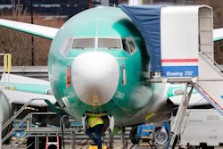 In this Dec. 16, 2019, file photo, a worker looks up underneath a Boeing 737 MAX jet, in Renton, Wash. Boeing has found a new software problem on its grounded 737 Max jetliner. The aircraft maker said, Friday, Jan. 17, 2020, it is making the necessary changes and working with the Federal Aviation Administration.