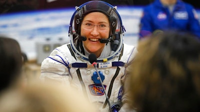 In this Thursday, March 14, 2019 file photo, U.S. astronaut Christina Koch, member of the main crew of the expedition to the International Space Station (ISS), speaks with her relatives through a safety glass prior the launch of Soyuz MS-12 space ship at the Russian leased Baikonur cosmodrome, Kazakhstan. Koch told The Associated Press on Tuesday, Jan. 28, 2020, her 319th consecutive day in space _ that taking part in the first all-female spacewalk was the highlight of her mission. She's been living on the International Space Station since March and returns to Earth on Feb. 6, landing in Kazakhstan with two colleagues aboard a Russian capsule.