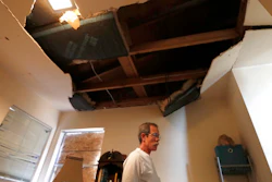 Kent Heap stands with a crumbling ceiling inside of his sister, Carol Goff's home, as people continued to sift through their damaged homes on Bridgeland Lane in Houston, Sunday, Jan. 26, 2020, after the Watson Grinding Manufacturing explosion early Friday morning.