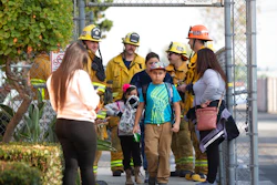 Children evacuate the Park Avenue Elementary school in Cudahy, Calif., Tuesday, Jan. 14, 2020 after an aircraft dumped fuel that fell onto the elementary school playground. Tuesday, Jan. 14, 2020. A jet returning to LAX dumped its fuel over the neighborhood and the school. Affected people at the school were treated for skin and eye irritation. No patients were transported to hospitals.