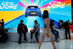 In this April 25, 2018, file photo, attendees visit the Ford booth during Auto China 2018 show held in Beijing, China. China’s government says it will postpone planned punitive tariffs on U.S.-made automobiles and other goods following an interim trade deal with Washington.Sunday, Dec. 15, 2019’s announcement came after Washington agreed to postpone a planned tariff hike on $160 billion of Chinese goods and to cut in half penalties that already were imposed.
