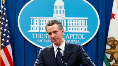 In this Jan. 10, 2020, file photo, California Gov. Gavin Newsom speaks at a news conference in Sacramento, Calif. Newsom is urging a federal judge to reject Pacific Gas and Electric's blueprint for getting out of bankruptcy and renewing his threat to lead a bid to turn the beleaguered utility into a government-run operation. PG&E is trying to dig out of a financial hole created by more than $50 billion in claims stemming from a series of catastrophic wildfires that have been blamed on the San Francisco company.