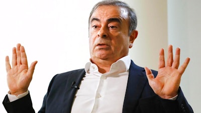 Former Nissan Chairman Carlos Ghosn speaks to Japanese media during an interview in Beirut, Lebanon, Friday, Jan. 10, 2020. A lawyer for Carlos Ghosn, Nissan's former chairman who skipped bail in Japan and fled to Lebanon, on Friday slammed a gaffe by the Japanese justice minister who said that Ghosn should “prove' his innocence. Ghosn, who was awaiting trial on financial misconduct charges, fled Tokyo and appeared in Beirut Dec. 30.