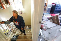 Maria Hernandez climbs her stairwell as she and her family worked to move their belongings out as they sifted through their damaged home in the Bridgeland Lane area of Houston, Sunday, Jan. 26, 2020, after the Watson Grinding Manufacturing explosion early Friday morning. Her ceiling, right, collapsed even further after overnight rains.