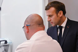 French President Emmanuel Macron speaks to an employee as he visits a plant of British-Swedish pharmaceutical group Astrazeneca in Dunkirk, northern France, Monday, Monday, Jan. 20, 2020. French President Emmanuel Macron is hosting 180 international business leaders later today at the Palace of Versailles in a bid to promote France's economic attractiveness despite over six weeks of crippling strikes over his government's planned pension changes.