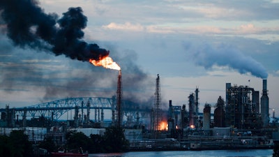 In this June 21, 2019 file photo, flames and smoke emerge from the Philadelphia Energy Solutions Refining Complex in Philadelphia. Federal investigators say an aging, failed elbow pipe appears to be the cause of the June fire and subsequent explosions that left five people with minor injuries and destroyed part of the processing unit at the largest oil refinery on the East Coast.