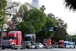 A caravan of trucks from the ports of Los Angeles and Long Beach drive around Los Angeles City Hall.