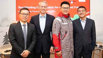 Coca-Cola Chairman and CEO James Quincey (center left), JD Logistics CEO Zhenhui Wang (far left), JD Retail CEO Lei Xu (far right) took a group photo with a JD staff member wearing a uniform made of recycled PET (rPET) materials co-created.