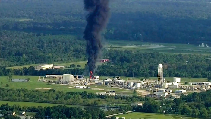 In this Sept. 1, 2017, file photo, smoke rises from the Arkema Inc. owned chemical plant in Crosby, near Houston, Texas. In February 2020, the Pennsylvania-based company, which is a subsidiary of a French chemical manufacturer, and three of its executives are set to stand trial in Houston in a case that legal experts say will be a challenge for prosecutors to win.