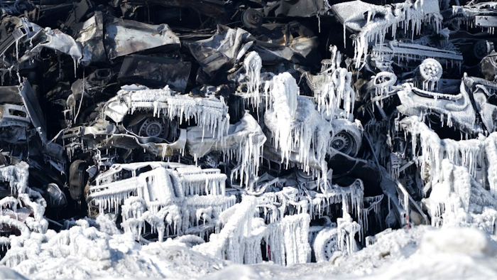 The massive fire at Northern Metal recycling in Becker, Minnesota, that has been burning for days, seemed to be under control Thursday, Feb. 20, 2020 with massive piles of burned cars covered in ice. The Becker Police Department posted Thursday that “major progress' has been made and that fire crews report the fire is “under control at this point.”