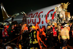 Rescue members evacuate an injured person from the wreckage of a plane after it skidded off the runway at Istanbul's Sabiha Gokcen Airport, in Istanbul, Wednesday, Feb. 5, 2020.