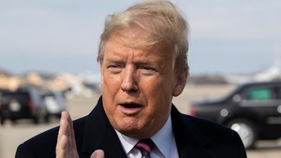 President Donald Trump speaks with reporters as he boards Air Force One as he departs Tuesday, Feb. 18, 2020, at Andrews Air Force Base, Md.