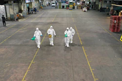 Workers wearing protective gears spray disinfectant as a precaution against the new coronavirus at Agricultural and Wholesale Products Center in Daegu, South Korea, Thursday, Feb. 20, 2020.