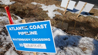 This Feb. 8, 2018, file photo shows signs that mark the route of the Atlantic Coast Pipeline in Deerfield, Va.