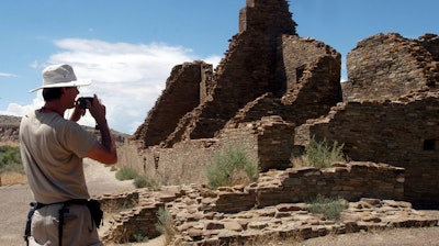 In this Aug. 10, 2005 file photo, tourist Chris Farthing from Suffolks County, England, takes a picture of Anasazi ruins in Chaco Culture National Historical Park in New Mexico.