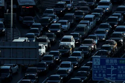 In this Dec. 11, 2018, file photo, a beam of sunlight is cast on vehicles on a city ring-road clogged with heavy traffic during the morning rush hour in Beijing, China. Auto sales in China have plunged, deepening a painful downturn in the industry’s biggest global market and adding to economic pressure as the country fights a virus outbreak.
