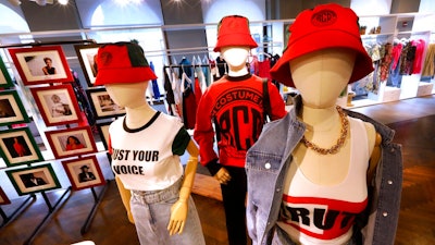 In this Feb. 20, 2020, photo, items from H&M’s new street wear collection are displayed at a store in New York. The collection was designed in collaboration with Ruth Carter, the Academy-Award winning designer behind the costumes for films such as “Black Panther” and “Malcolm X.' It debuted as more companies and brands are getting into the business of Black History Month but also trying not to leave the impression that African American consumers are important just once a year.