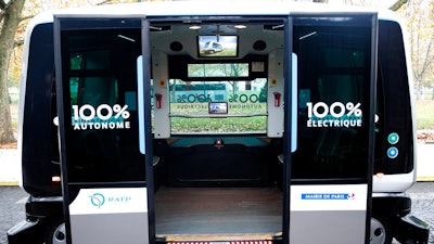This Nov. 17, 2017, file photo shows a view inside an electric driverless shuttle produced by EasyMile, during an experiment, in Paris. The U.S. government's highway safety agency has ordered an autonomous shuttle company to stop carrying passengers in 16 U.S. cities after a mysterious braking problem occurred in Columbus, Ohio. The National Highway Traffic Safety Administration says the suspension will remain in place while it examines safety issues with the low-speed shuttles operated by France-based EasyMile.