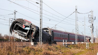 An overturned carriage of a high-speed train after the train derailed in the countryside near the town of Lodi, northern Italy, Thursday, Feb. 6, 2020. A high-speed passenger train derailed in northern Italy before dawn on Thursday on the heavily used Milan-Bologna line, with the motor car completely detaching, killing two railway workers and injuring 27 people, authorities said.