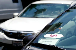 In this July 9, 2019, file photo a Lyft ride-share car waits at a stoplight in Sacramento, Calif. Ride-hailing service Lyft's annual loss more than doubled last year to over $2.6 billion, but the company claimed progress as revenue jumped 68% and ridership grew.