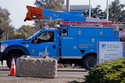 In this Feb. 11, 2020, file photo a Pacific Gas & Electric truck leaves the company's Oakland Service Center in Oakland, Calif. Pacific Gas and Electric said Tuesday, Feb. 18, that it expects to become more profitable than ever after it emerges from bankruptcy and pays off more than $25 billion in losses sustained in catastrophic wildfires ignited by its outdated equipment.